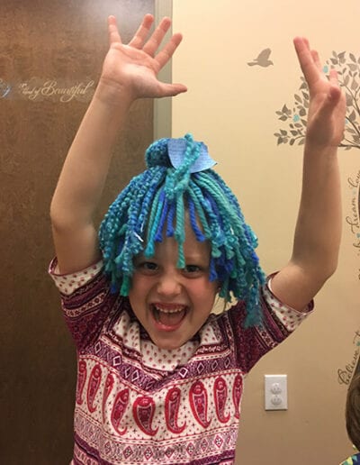 Creative Kids Fort Mill | child wearing yarn wig