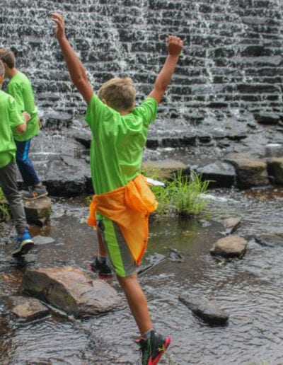 Creative Kids Fort Mill | children having fun at camp walking in stream